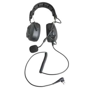 Black over-ear headset with attached boom microphone and coiled cable, photographed on a white surface against a white wall.